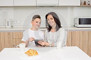 Mother and son using digital tablet