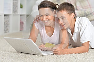 Mother and son using laptop photo