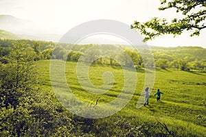 Mother and son walk in field