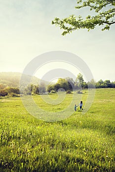 Mother and son walk in field