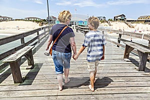Mother and son walking hand in hand