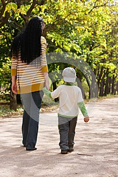 Mother and son walking in park