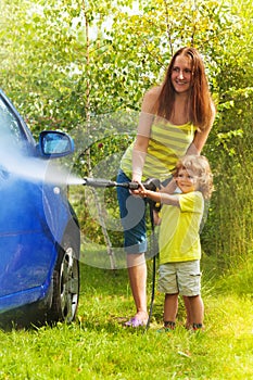 Mother and son washes the car