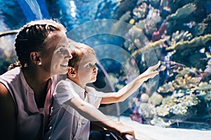 Mother and son watching sea life in oceanarium