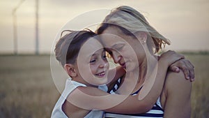 Mother and son in wind turbines field