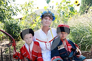 Mother and sons in Cossack costumes