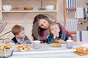 Mother and sons having breakfast.