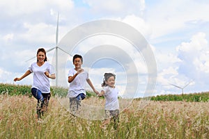 Mother and sons playing in field