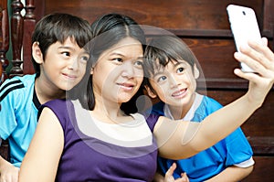 Mother and sons taking selfie with mobile