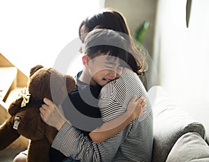 Mother sooth her son from sadness photo