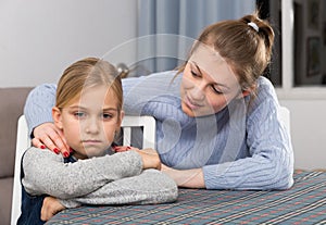 Mother soothes  daughter after an quarrel