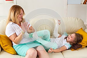 Mother spend time with your child girl with a cast on a broken wrist or arm smiling. Childhood illnesses, a positive