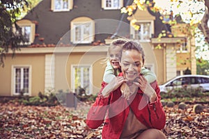 Mother spending time with daughter. Autumn season.