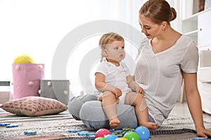 Mother spending time with her baby at home