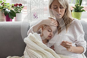 Mother staying at home with her sick child photo