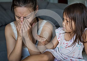 Stressed out mother tired and overwhelmed with her child at home. Parenting problems photo