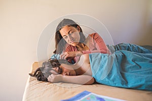 Mother stroking the head of a sleeping child