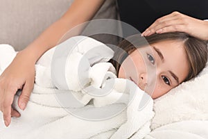 Mother stroking her daughter, lying on moms knees