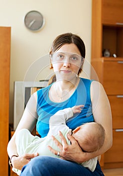 Mother sucking half-year-old baby