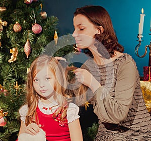 MOTher and sun and daughter near Christmas tree