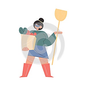 Mother in superhero mask standing with shopping bag and household in hands