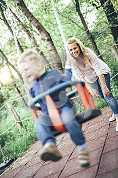 Mother swinging her child outdoor