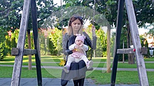 Mother swinging with her daughter