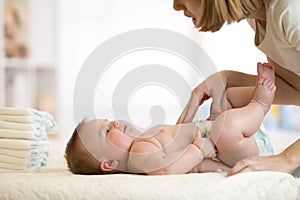 Mother taking care of little baby and changing diaper