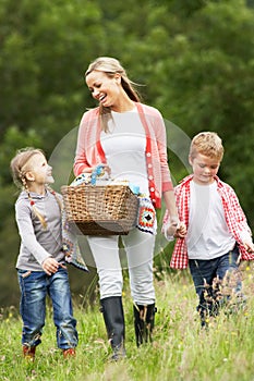 Mother Taking Children On Picnic In Countryside