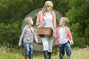 Mother Taking Children On Picnic In Countryside