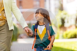 Mother taking her daughter to school