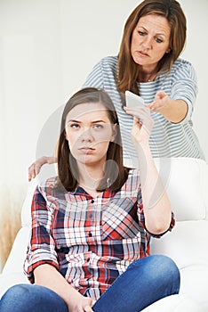 Mother Taking Mobile Phone Away From Teenage Daughter
