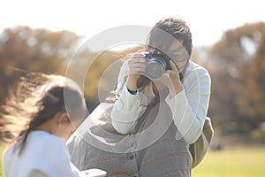 Mother taking pictures of children