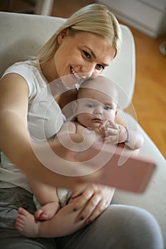 Mother taking self portrait of her and her baby boy.