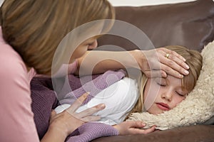 Mother Taking Temperature Of Sick Daughter