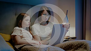 Mother teach daughter at late evening