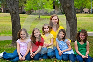 Mother teacher with daughter pupils in playground park