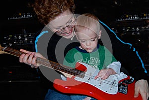 Mother Teaches Child Guitar Music Lesson