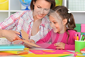 Mother teaches her cute daughter to do craft items