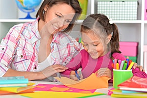 Mother teaches her cute daughter to do craft items