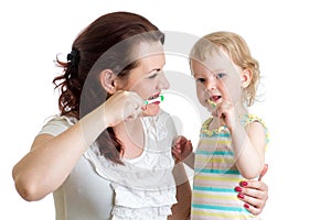 Mother teaches her daughter kid teeth brushing photo