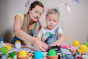 Mother teaches kid to do craft items