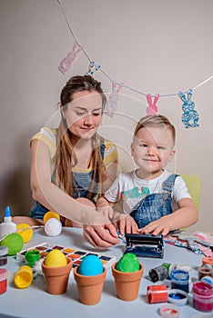 Mother teaches kid to do craft items