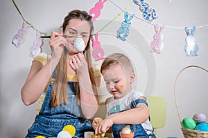 Mother teaches kid to do craft items