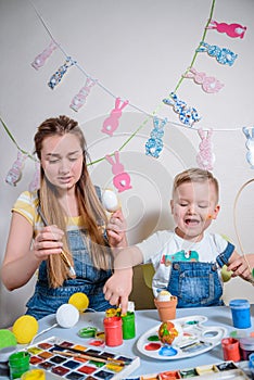 Mother teaches kid to do craft items