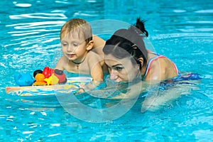 Mother teaching baby boy to swim