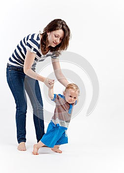 Mother teaching baby to walk