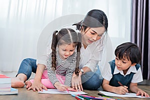 Mother teaching children in drawing class. Daughter and son pain