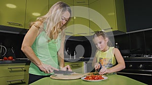 Mother teaching daughter smart girl learning to cook. Mistress children to cook a Neapolitan egg fried omelette from