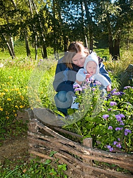 Mother teaching flowers her baby